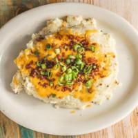 Loaded Mashed Potatoes · Creamy mashed potatoes with cheese, bacon bits, sour cream, and chives.