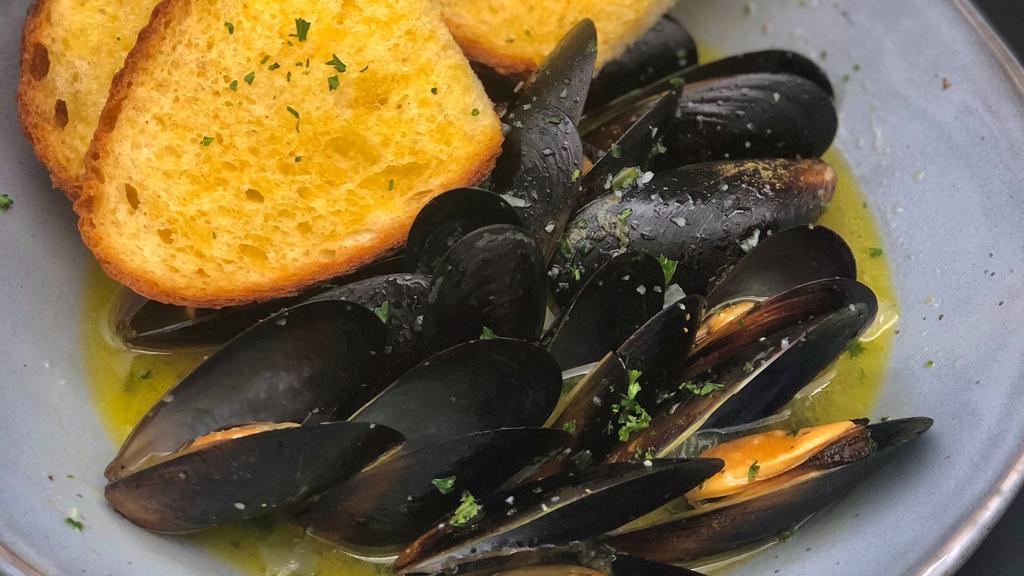 Cozze Veneziana · Sweet and tender black mussels sautéed with parsley & olive oil, and simmered in a white wine sauce.