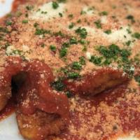 Pollo Parmigiana · Juicy chicken breast, lightly breaded, topped with a slice of Italian ham and imported Mozza...