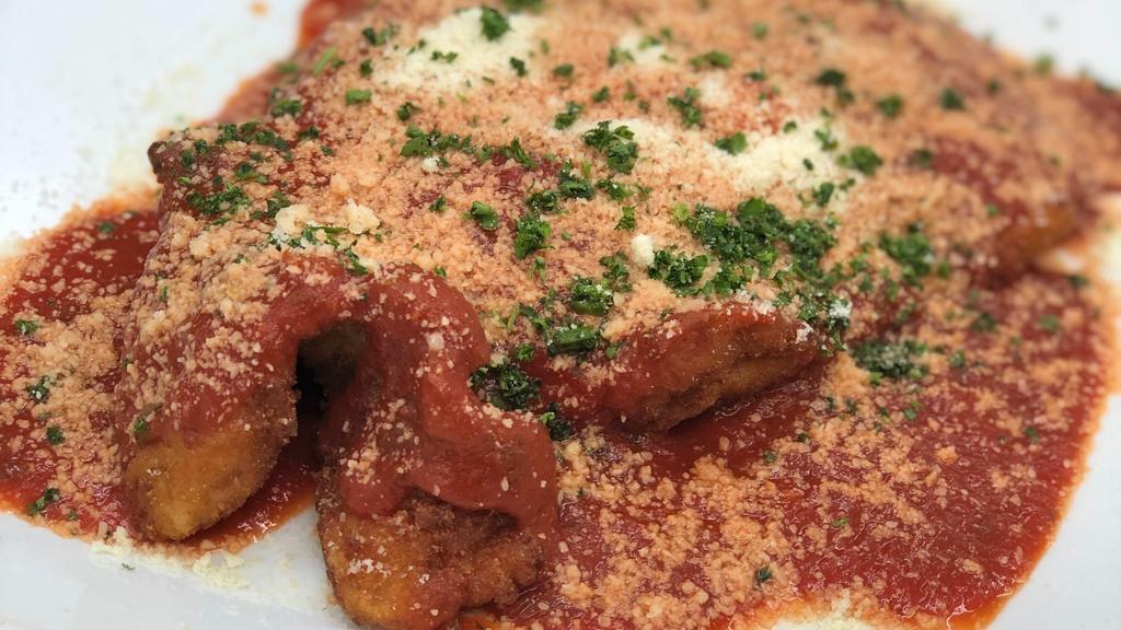Pollo Parmigiana · Juicy chicken breast, lightly breaded, topped with a slice of Italian ham and imported Mozzarella cheese, and covered with homemade marinara sauce.