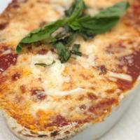 Parmigiana Di Melanzane · Lightly fried eggplant thinly sliced and layered with Mozzarella and Parmigiano cheese, bake...