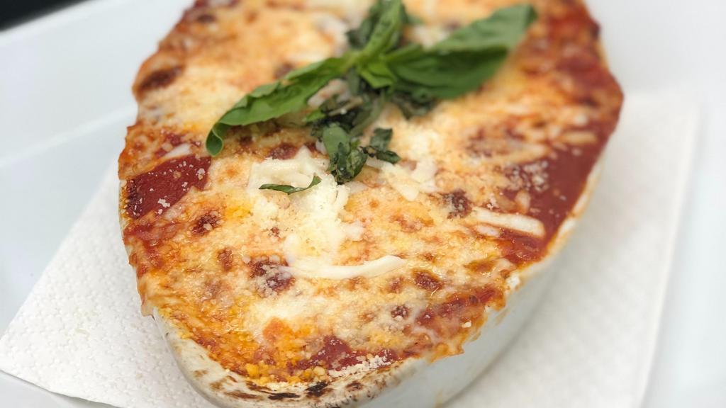 Parmigiana Di Melanzane · Lightly fried eggplant thinly sliced and layered with Mozzarella and Parmigiano cheese, baked to perfection and covered with marinara sauce.