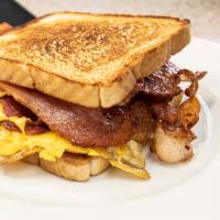 Breakfast Sandwich · Toasted bread with egg, choice of meat, and American cheese.