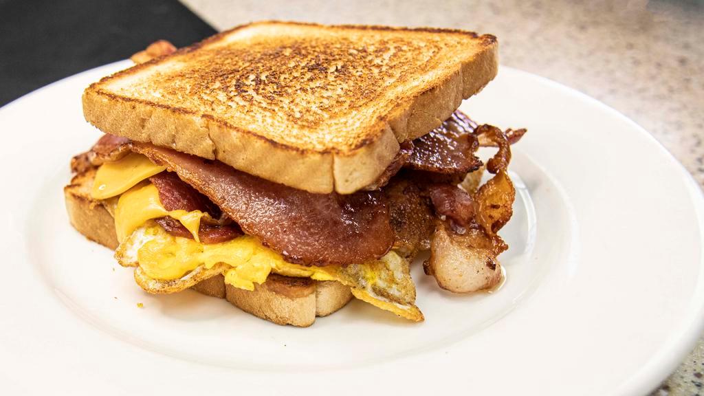 Breakfast Sandwich · Toasted bread with egg, choice of meat, and American cheese.