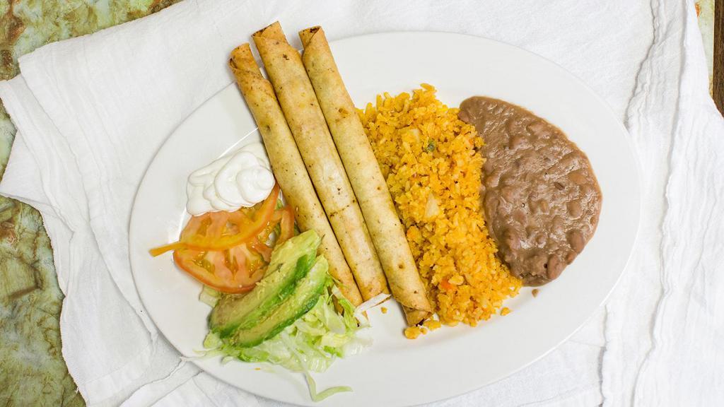 Chicken Flautas · Rolled-up tortilla that contains chicken served with rice and beans.