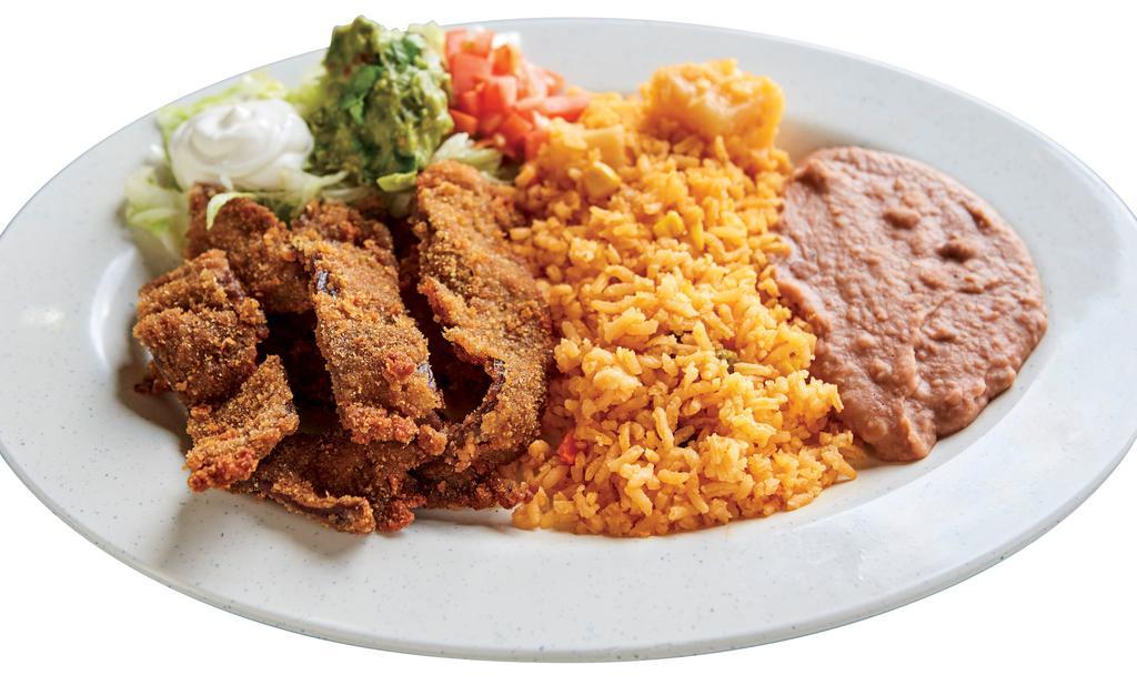 Beef Milaneza · Choice of corn or flour tortilla. A thin cut of meat that is breaded and fried served  with rice and beans. (Lettuce, Sour Cream, Tomatoes, Guacamole).