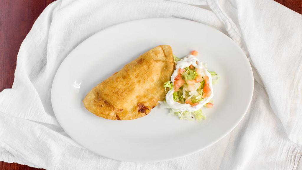 Chicken Empanada (Each) · Baked chicken empanada made of chicken filling enclosed in a buttery and flaky pie crust.