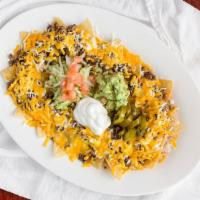 Nacho Plate · Consist of tortilla chips covered with melted cheese. (Chips, Beans, Choice of Meat, Mozzare...