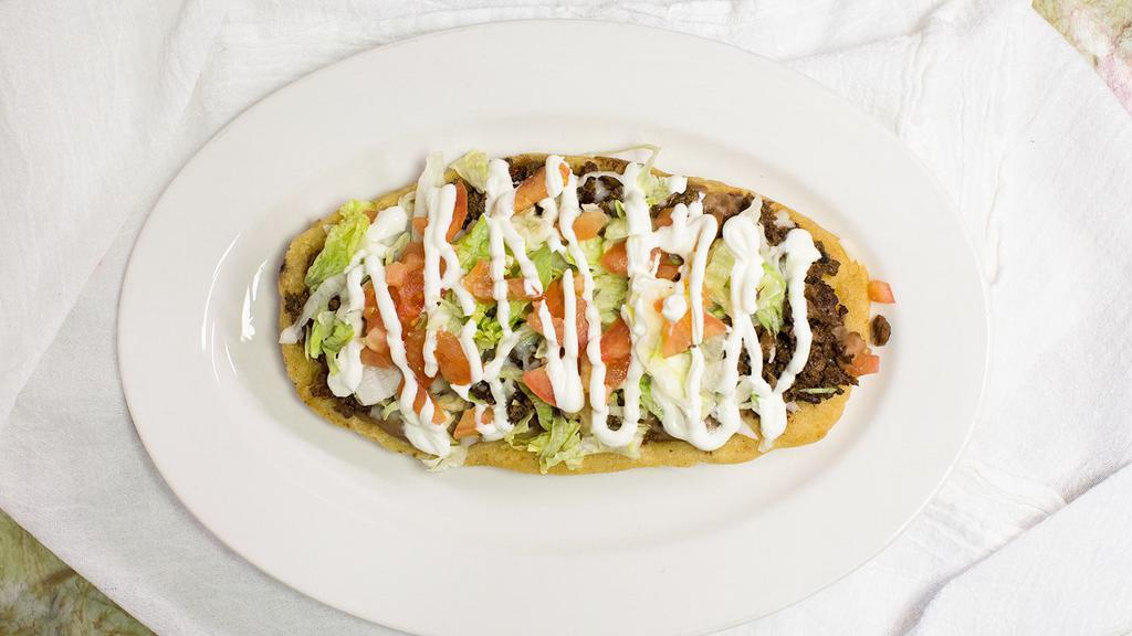 Huarache · Authentic Mexican Huarache consisting of masa served with your choice of meat. (Beans, Meat, Lettuce, Sour Cream, Tomatoes, Queso Fresco).