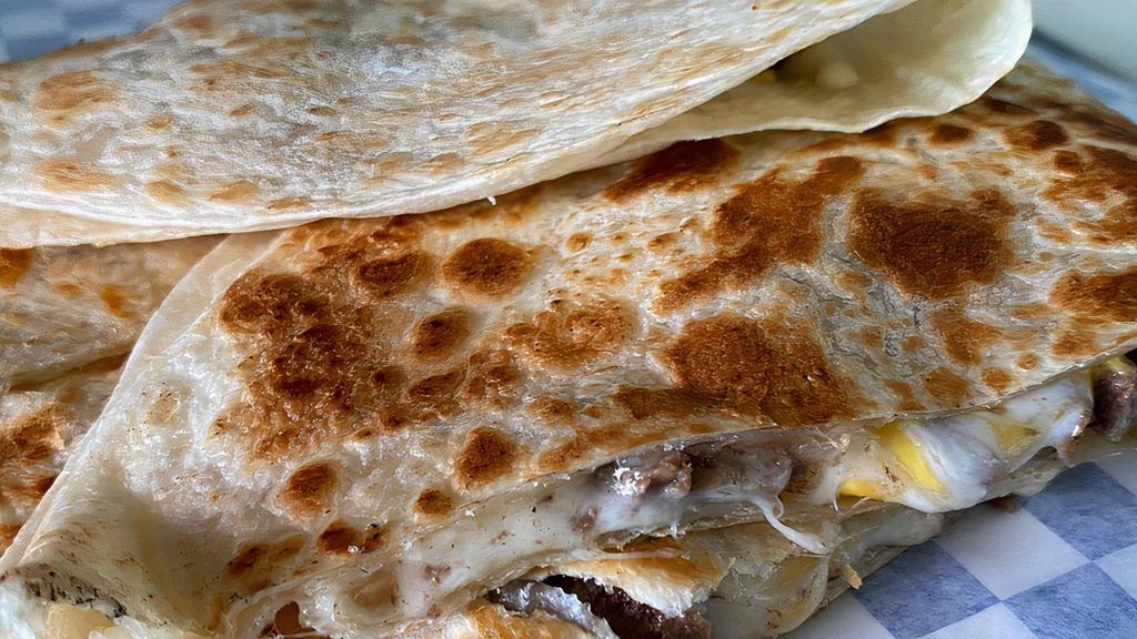 King Quesadilla · Large 10” Flour Quesadilla, Choice of Beef or Chicken Includes sour cream & Hot Sauce on the side