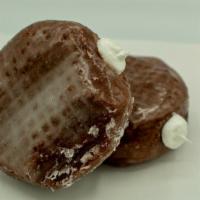 Chocolate Cream Filled · Yeast raised chocolate dough shell donut filled with white whipped cream filling