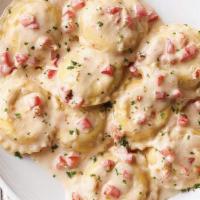 Lobster Ravioli · Ravioli stuffed with lobster and romano in our white wine cream sauce topped with diced toma...