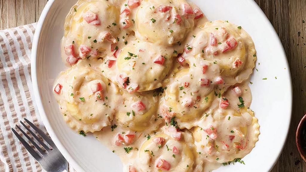 Lobster Ravioli · Ravioli stuffed with lobster and romano in our white wine cream sauce topped with diced tomatoes