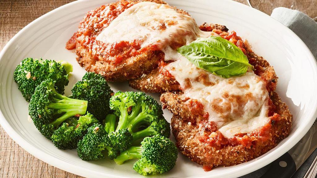 Eggplant Parmesan · Layers of sliced eggplant coated with seasoned breadcrumbs and topped with pomodoro sauce, mozzarella and romano cheese
