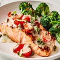 Salmon Capperi · Wood-grilled Salmon topped with
oven-roasted grape tomatoes,
fresh basil, capers and our
lem...