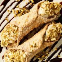 Traditional Cannoli** · Two crisp mini pastry shells stuffed with sweet ricotta and chocolate chip filling, topped w...