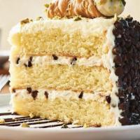 Cannoli Cake For Two** · Vanilla cake with layers of cannoli filling topped with a mini cannoli, pistachios and choco...