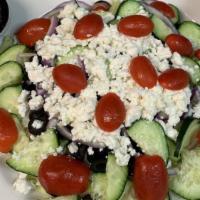 Greek Salad · Lettuce, feta cheese, red onion, cucumber, black olives, and tomato.