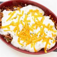 Loaded Hash Browns · Golden-crispy hash browns, topped with two eggs, sausage gravy, cheese, and sautéed onion, s...
