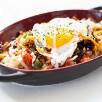 Sunny'S Skillet · Hash browns piled high with chorizo, cheese, crema, house salsas & a fried egg. Served with ...