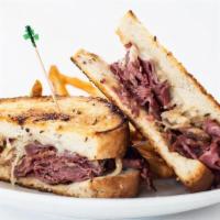 Signature Reuben · Thinly sliced corned beef stacked high, sauerkraut, swiss cheese & thousand island on thick-...