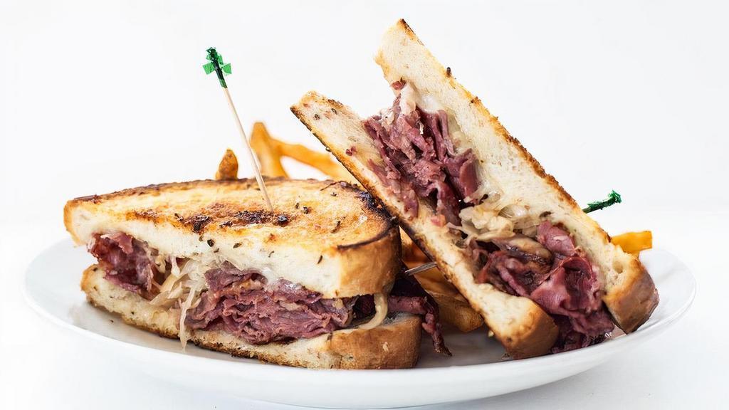 Signature Reuben · Thinly sliced corned beef stacked high, sauerkraut, swiss cheese & thousand island on thick-sliced grilled rye