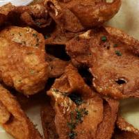 Fried Cajun Chicken Cracklings · Crispy fried cajun marinated chicken skin, served with ranch dressing.