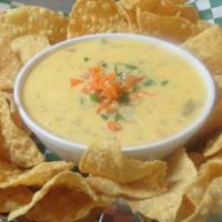 Chips  & Queso · Cheese sauce, ground beef , Spicy.