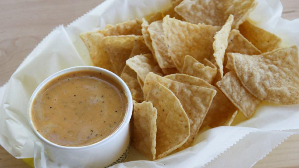 Queso & Chips · Housemade Queso with Tacodeli tortilla chips