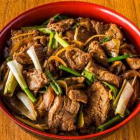 Mongolian Beef Bowl · Stir-fried slice Beef, Green onion, Yellow Onion served on top of rice bowl.