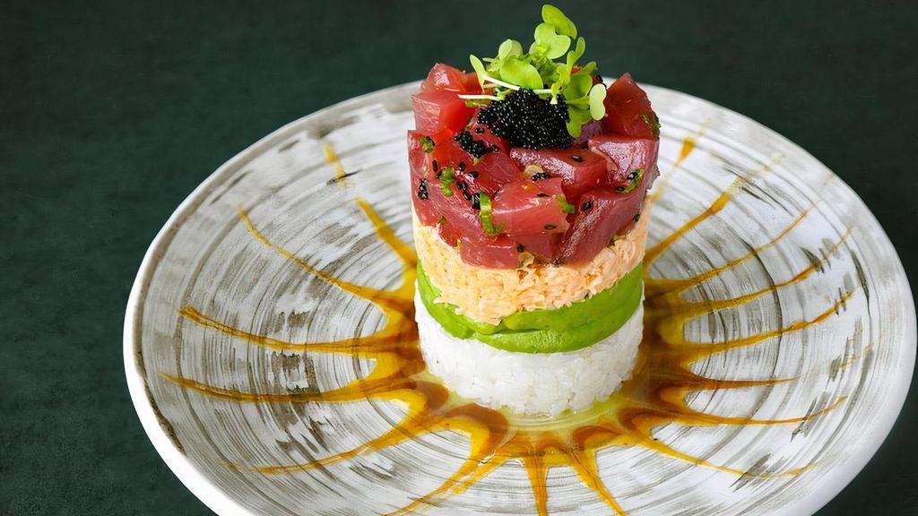 *Tuna Tower · sesame and ponzu-marinated bigeye tuna, spicy crab mix, avocado and sushi rice, topped with black tobiko and wasabi sprouts, served with honey wasabi, mango and eel sauces