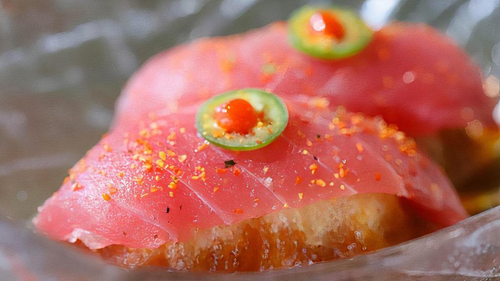 *Cherry Bomb · bigeye tuna on top of rice tempura, topped with serrano, sriracha, togarashi and ponzu sauce (2 pcs)