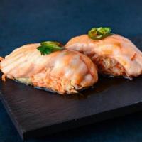 Itchy Salmon · baked atlantic salmon on top of spicy crab mix, topped with serrano, cilantro and ponzu sauc...