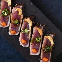 *Tuna Tataki · Pepper seared skipjack tuna topped with daikon Momiji, garlic chips, scallion and tataki sau...