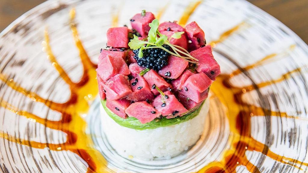 Vegan Tuna Tower · sesame and ponzu-marinated plant based tuna, avocado and sushi rice, topped with black tobiko and wasabi sprouts, served with mango and sweet soy sauce