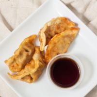 Gyoza · Four pieces fried chicken pot stickers with Japanese soy dipping sauce.