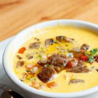 Garcia’S Queso · delicious blend of queso mixed with sausage, onion, tomato, and serrano peppers. Chips inclu...