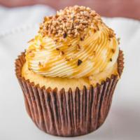 Caramel Vanilla Cupcake · Vanilla cupcake topped with our signature cream cheese frosting, caramel drizzle and pecan p...