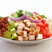 Mexican Cobb Salad · Tender grilled chicken breast, diced tomatoes, avocado, chorizo & queso fresco on a bed of m...
