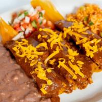 Beef Tamales (Three) · Served with chili con carne, pico de gallo, rice & refried beans