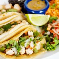 Street Tacos (Three) · charbroiled steak or marinated grilled chicken, served on corn tortillas with cilantro, onio...