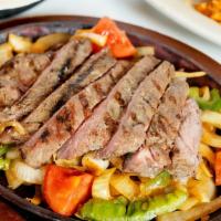 Sizzling Fajitas · With sauteed onions, bell peppers and tomatoes
