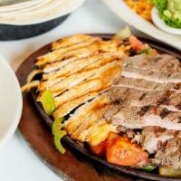 Sizzling Fajitas For Two · With sauteed onions, bell peppers and tomatoes