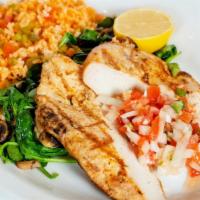 Pollo A La Parilla · Grilled chicken beast on a bed of sautéed fresh spinach & mushrooms, served with rice & pico...