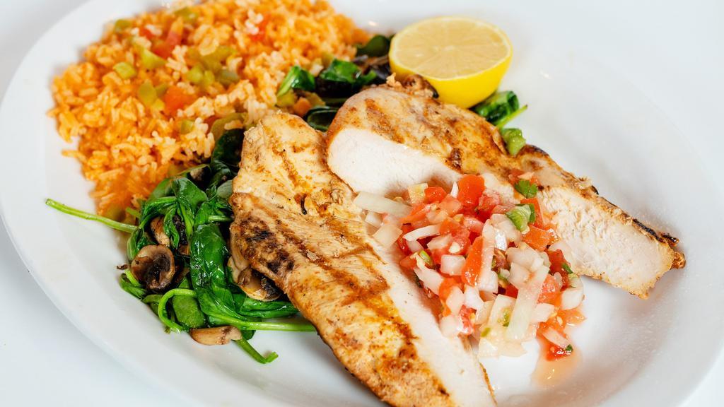 Pollo A La Parilla · Grilled chicken beast on a bed of sautéed fresh spinach & mushrooms, served with rice & pico de gallo