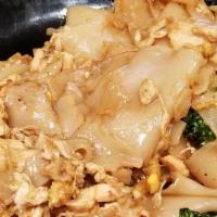 Pad See Ew · Stir-fried rice noodles in black sauce with egg and broccoli.