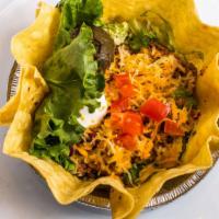 Taco Salad · Large taco shell filled with lettuce, tomatoes, grated cheese, red onions, guacamole, sour c...
