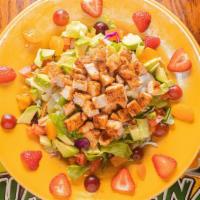 Tropical Salad · Served on a bed of fresh lettuce with chicken salad, avocados, tomatoes, mandarin oranges, g...
