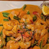 Panang Curry · Mild spicy. Green beans, bell peppers and lime leaves in coconut milk. Served with steamed r...