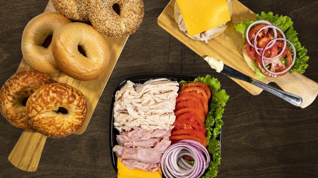 Bagel Deli Kit · An easy lunch solution for your group, this kit comes with 6 bagels (2 Plain, 2 Everything, 2 Asiago), deli Turkey, deli Ham, and an assortment of sandwich toppings for 6 sandwiches.